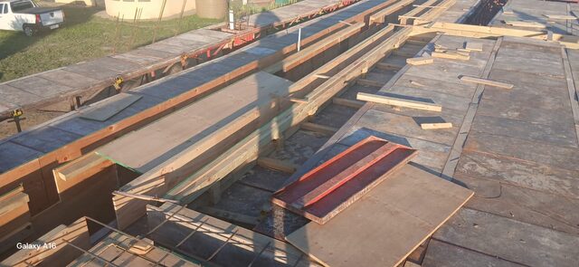 Timber beam and plywood deck suspended slab formwork viewed from above, showing parallel runners and full deck coverage